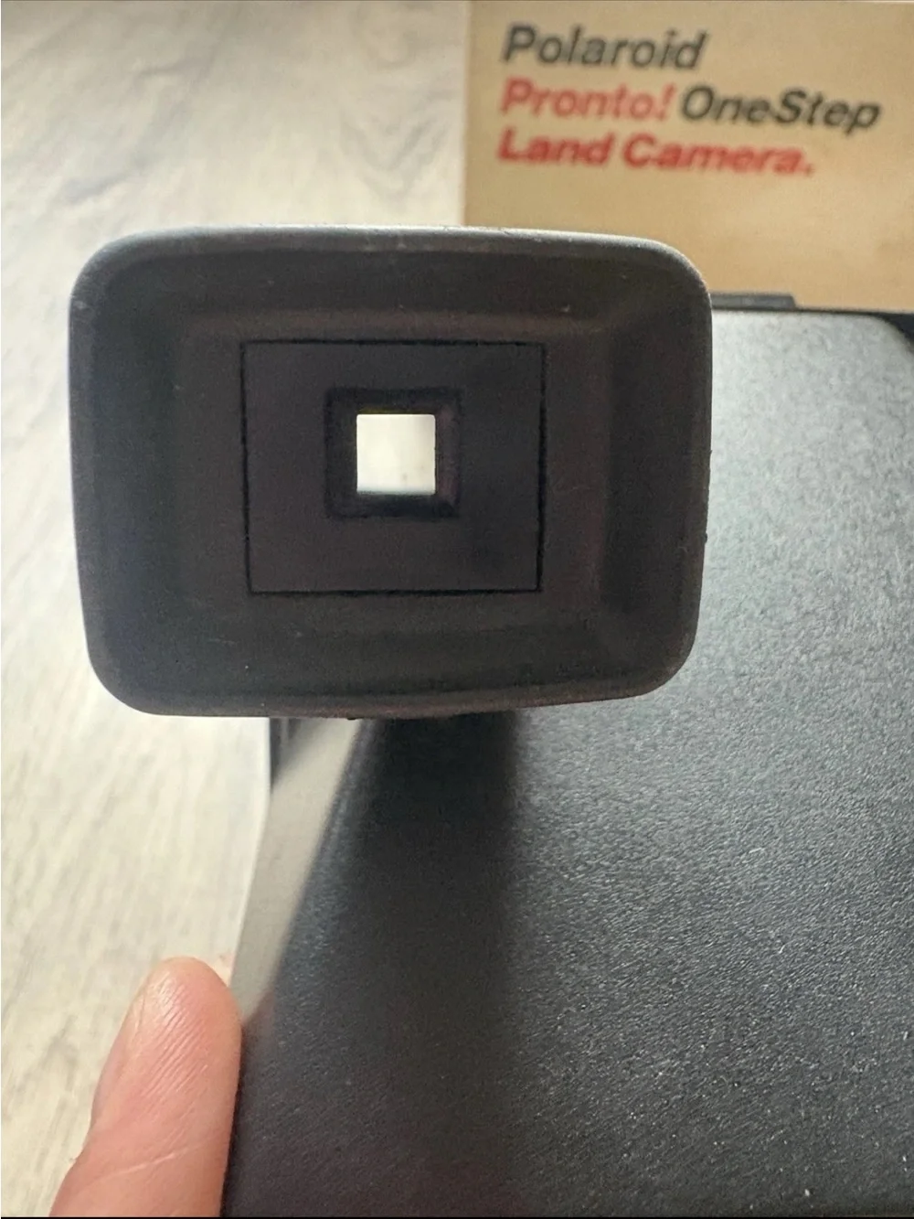 Polaroid OneStep Land Camera — cream body with rainbow stripe